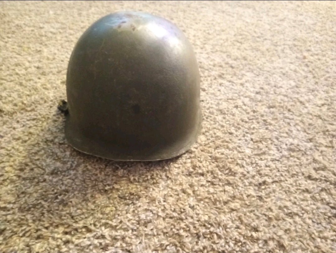 Authentic WWII U.S. Army M1 steel helmet shell, featuring honest battlefield wear and a hand - painted soldier name: “Keane” - Workshop & Study