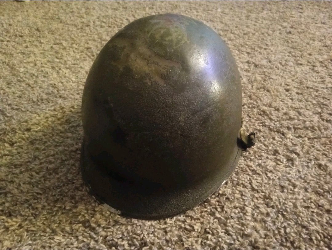 Authentic WWII U.S. Army M1 steel helmet shell, featuring honest battlefield wear and a hand - painted soldier name: “Keane” - Workshop & Study