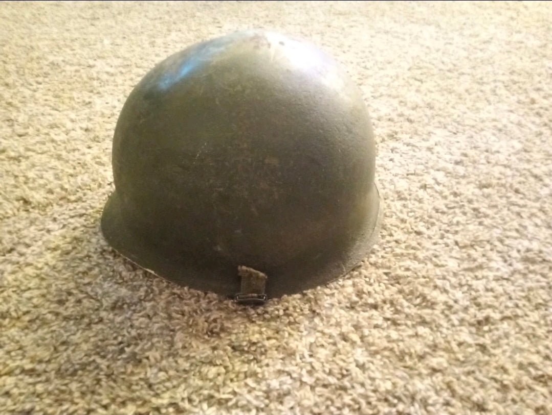 Authentic WWII U.S. Army M1 steel helmet shell, featuring honest battlefield wear and a hand - painted soldier name: “Keane” - Workshop & Study